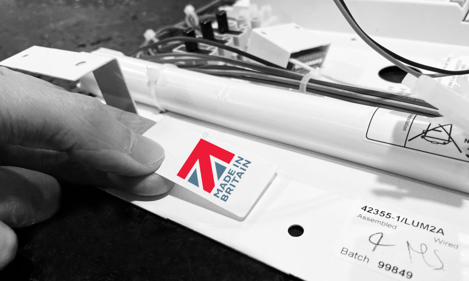 Affixing a Made In Britain logo label during product assembly